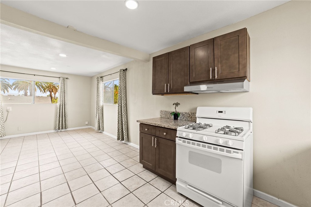 3717 Roosevelt Street Riverside, CA 92503 - Photo 18 of 23 a kitchen with a stove sink and cabinets