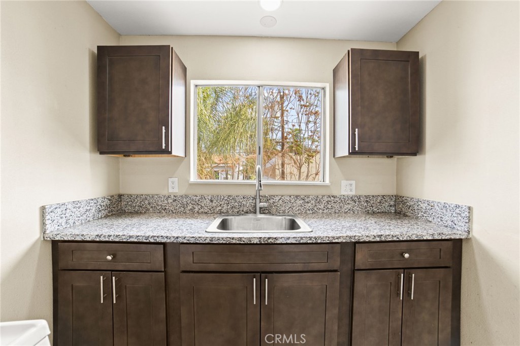 3717 Roosevelt Street Riverside, CA 92503 - Photo 19 of 23 a bathroom with a granite countertop sink and a mirror