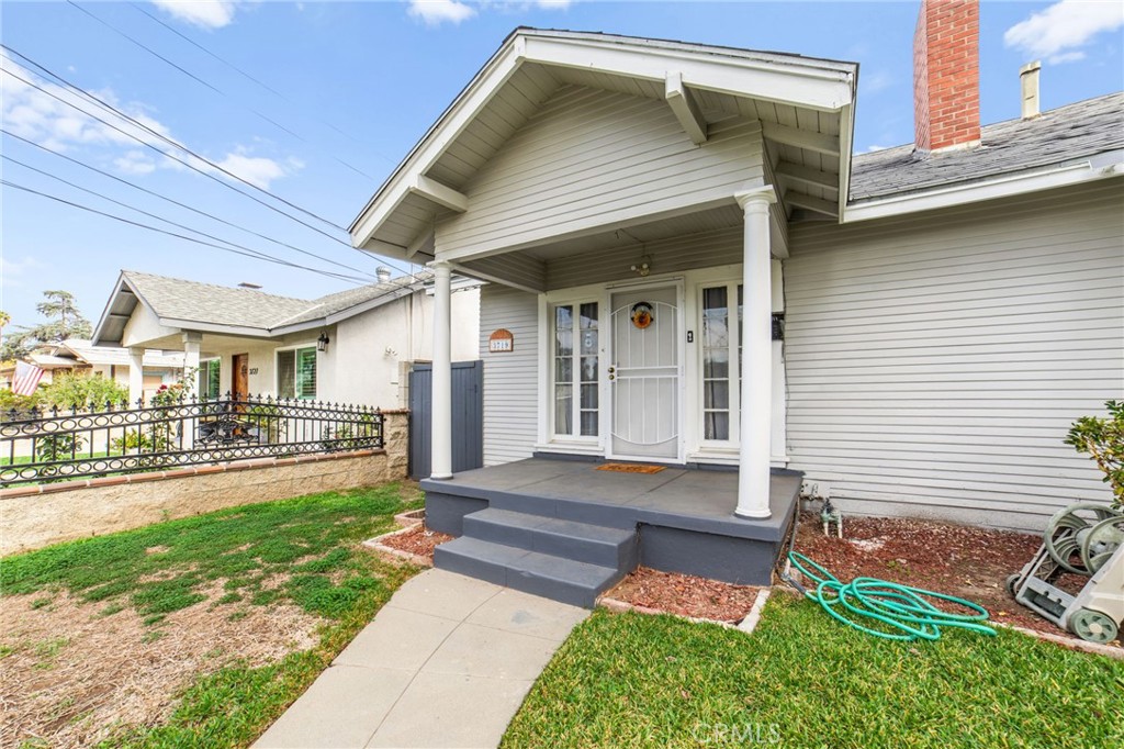 3717 Roosevelt Street Riverside, CA 92503 - Photo 4 of 23 a front view of a house with a yard and garage