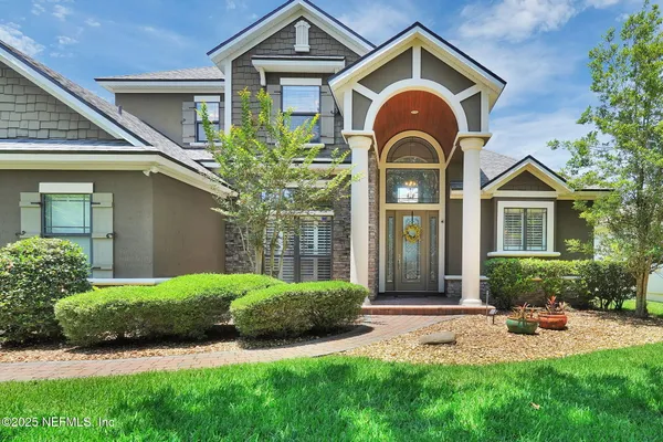 a front view of a house with garden