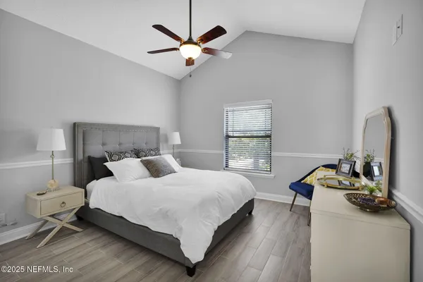 a bedroom with a bed and a chandelier