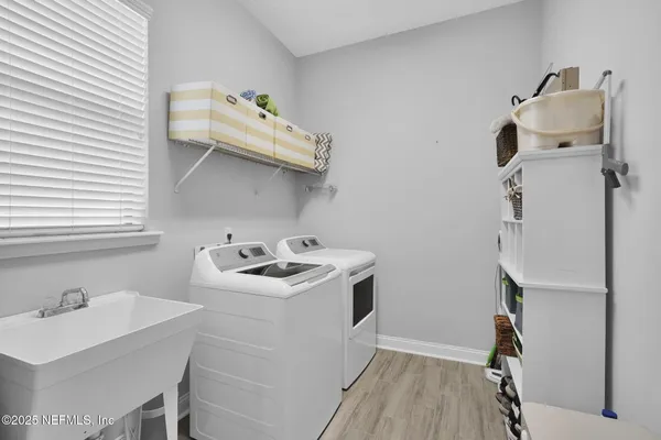 a utility room with sink dryer and washer