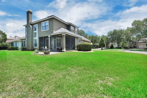 a front view of a house with a yard and sitting area