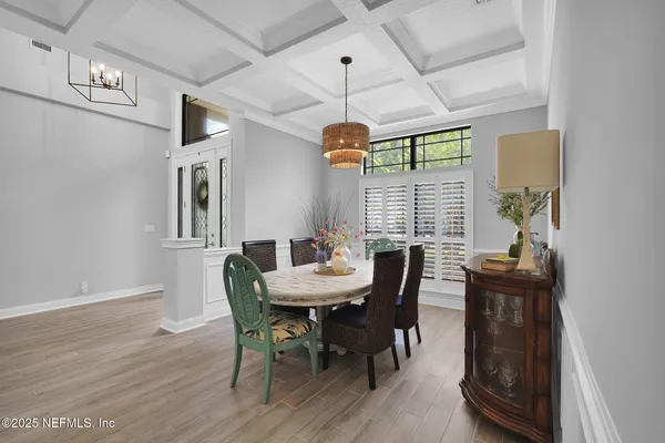 a view of a dining room with furniture window and wooden floor