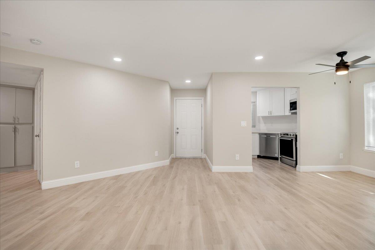 127 Rancho Drive San Jose, CA 95111 - Photo 7 of 25 an empty room with wooden floor fireplace and windows