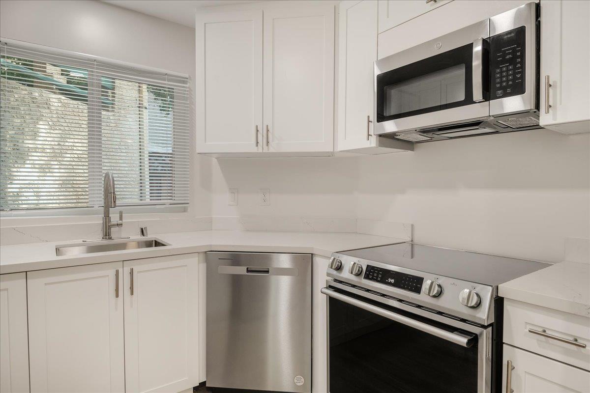 127 Rancho Drive San Jose, CA 95111 - Photo 9 of 25 a kitchen with a stove and a microwave