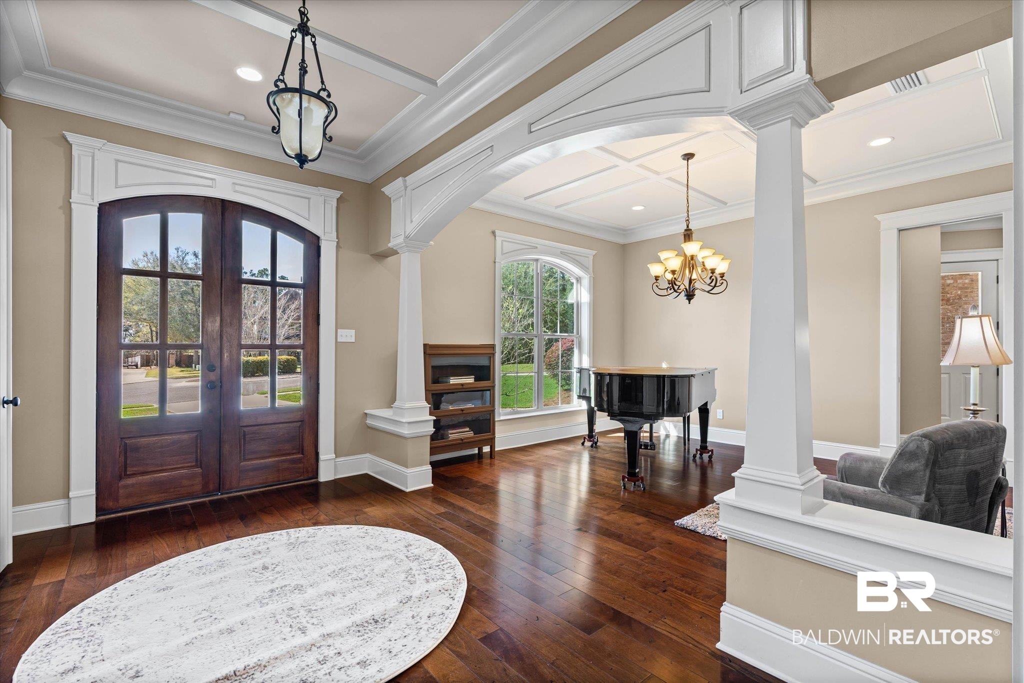 7676 Rockstone Lane Mobile, AL 36695 - Photo 4 of 47 Entrance foyer with decorative columns, arched walkways, french doors, dark wood-style floors, and crown molding