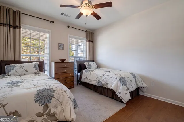 a bedroom with two beds and a chandelier