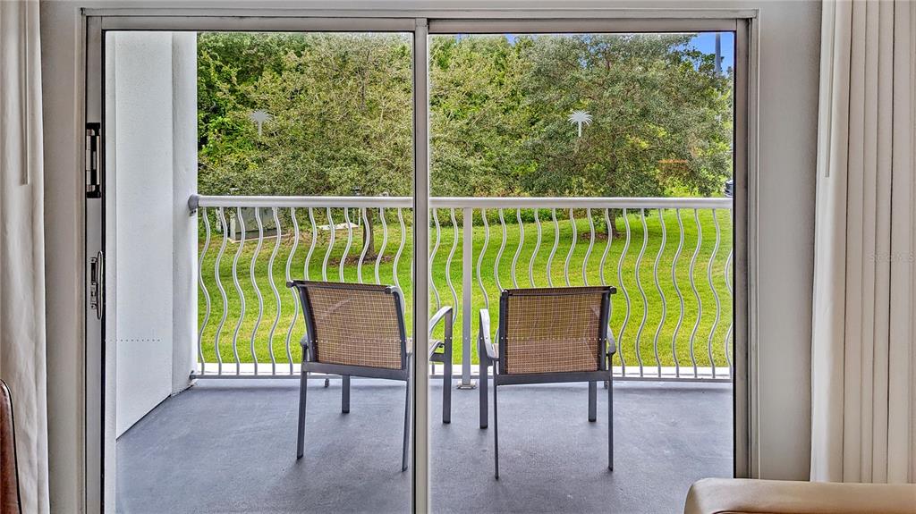 225 Celebration Place, Unit 212 Celebration, FL 34747 - Photo 12 of 35 a view of two chairs in the balcony