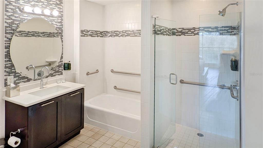 225 Celebration Place, Unit 212 Celebration, FL 34747 - Photo 19 of 35 a bathroom with a bath tub sink mirror and shower