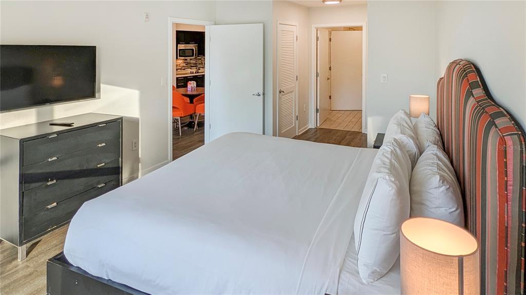 225 Celebration Place, Unit 212 Celebration, FL 34747 - Photo 21 of 35 a bedroom with a bed and a flat screen tv