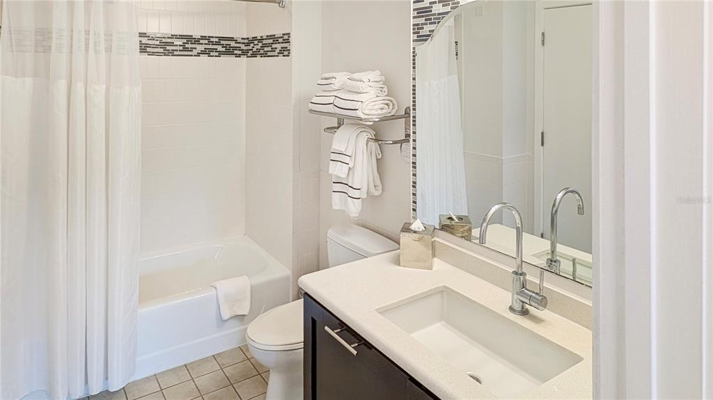 225 Celebration Place, Unit 212 Celebration, FL 34747 - Photo 22 of 35 a bathroom with a sink a toilet and shower