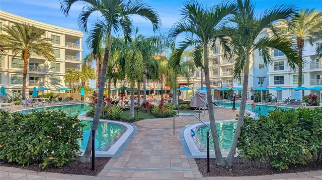 a view of a patio with a table and chairs under an umbrella