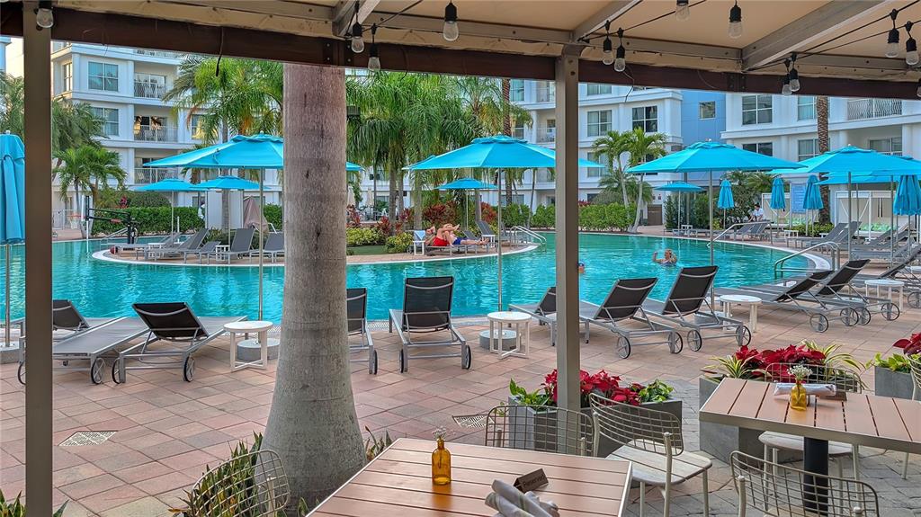 225 Celebration Place, Unit 212 Celebration, FL 34747 - Photo 33 of 35 a view of a patio with a table and chairs under an umbrella