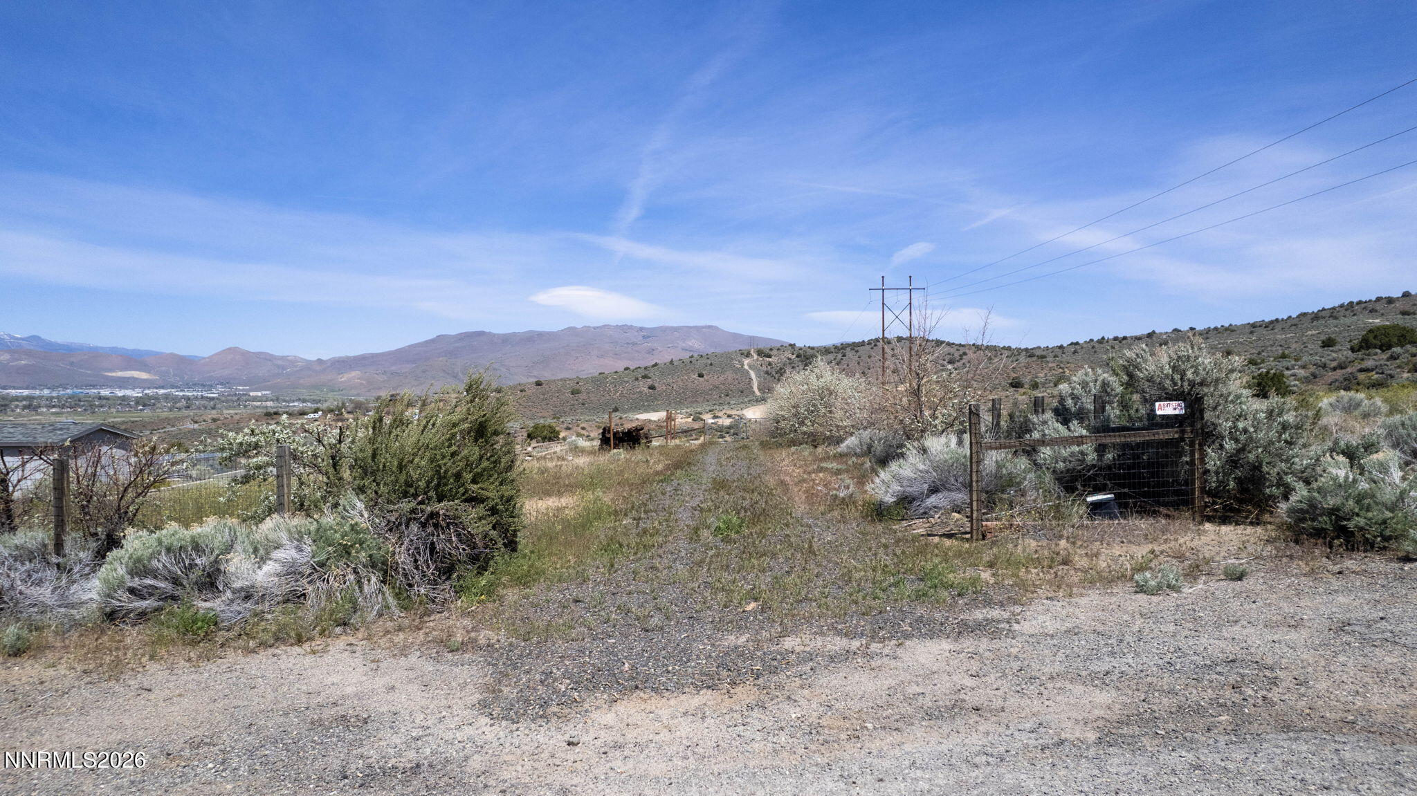 6260 Pursia Road Carson City, NV 89701 - Photo 10 of 26 a view of a dry yard with mountains in the background