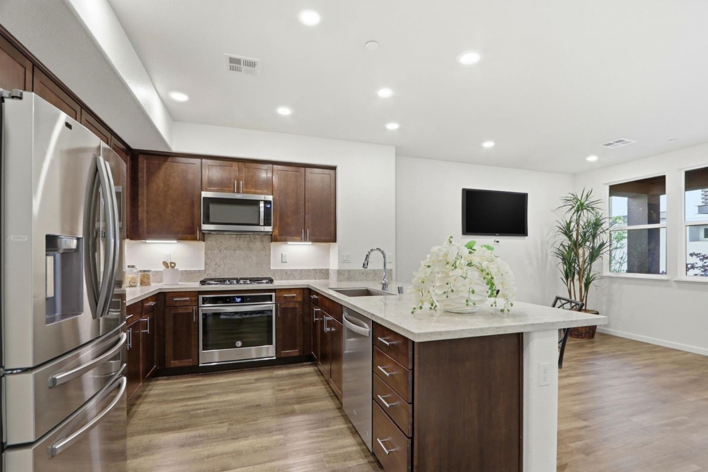 637 Clover Circle Milpitas, CA 95035 - Photo 11 of 39 a kitchen with stainless steel appliances granite countertop a sink stove and refrigerator