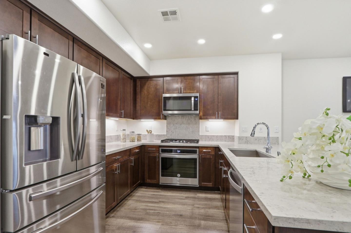637 Clover Circle Milpitas, CA 95035 - Photo 12 of 39 a kitchen with stainless steel appliances granite countertop a sink stove and refrigerator