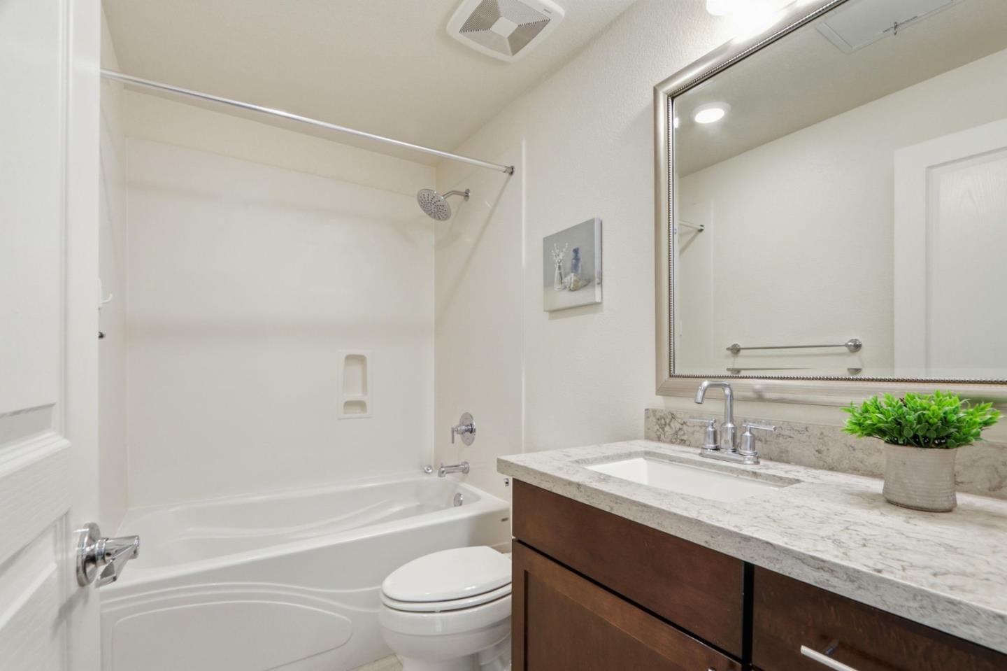 637 Clover Circle Milpitas, CA 95035 - Photo 24 of 39 a bathroom with a granite countertop sink a toilet and shower