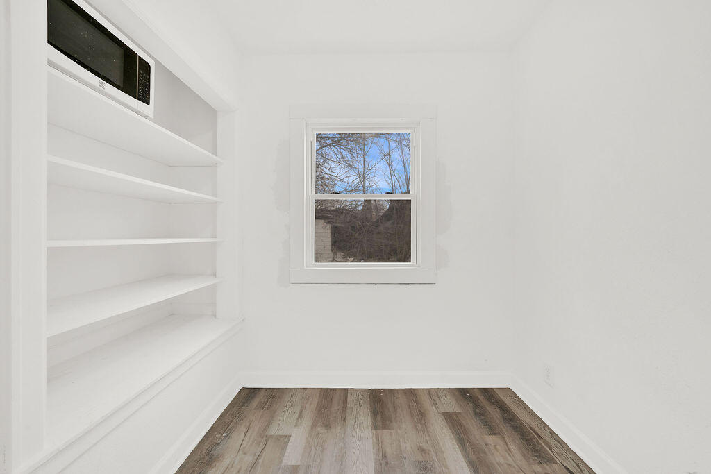 4084 Tyler Street Gary, IN 46408 - Photo 11 of 21 a view of a hallway with wooden floor and a window