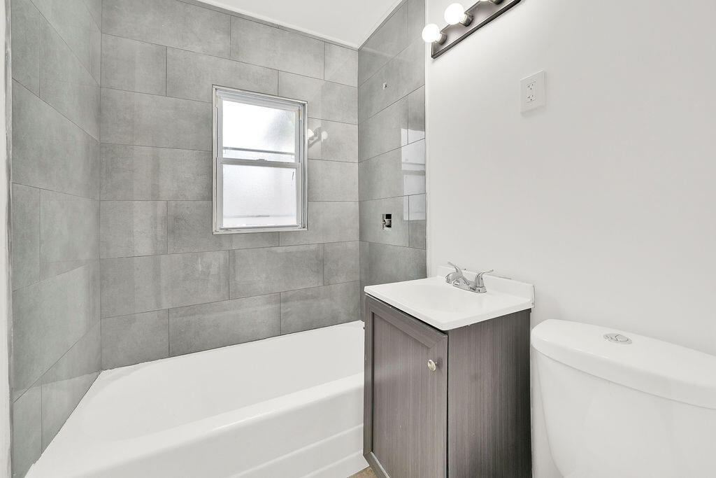 4084 Tyler Street Gary, IN 46408 - Photo 12 of 21 a bathroom with a sink toilet and bathtub