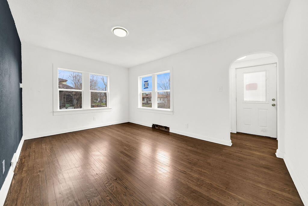 4084 Tyler Street Gary, IN 46408 - Photo 5 of 21 a view of an empty room with wooden floor and a window