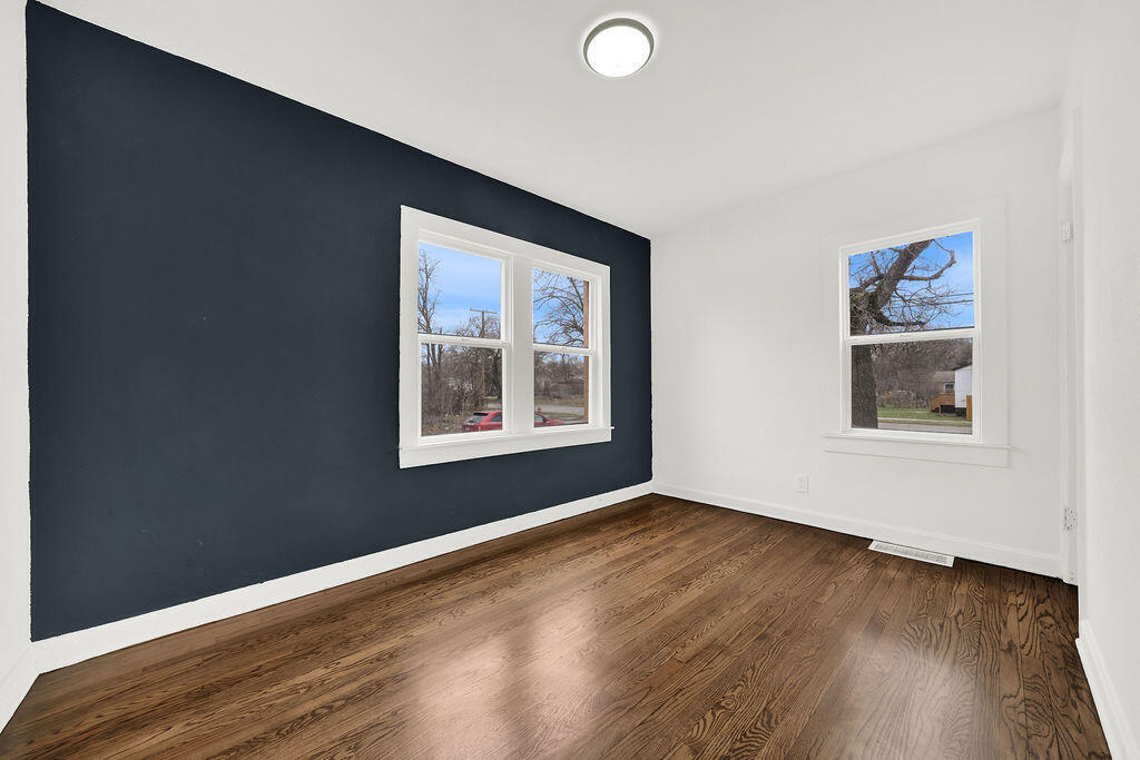 4084 Tyler Street Gary, IN 46408 - Photo 7 of 21 a view of an empty room with wooden floor and a window