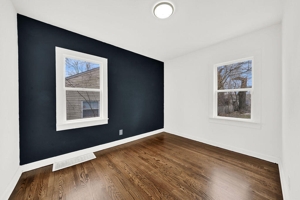 4084 Tyler Street Gary, IN 46408 - Photo 9 of 21 a view of an empty room with wooden floor and a window
