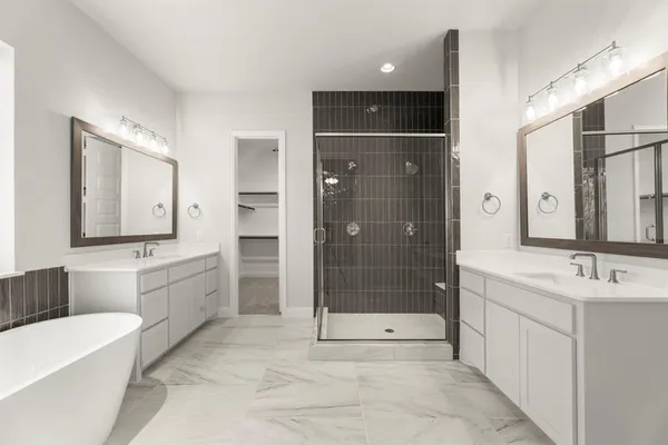 a spacious bathroom with a shower a sink and mirror