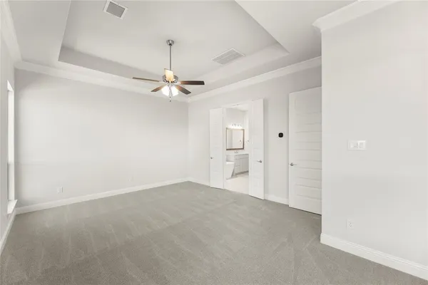 a view of a room with a ceiling fan and a rug