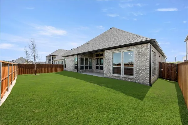 a view of a house with a yard and porch
