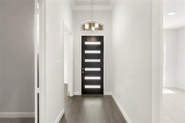 a view of a hallway with wooden floor