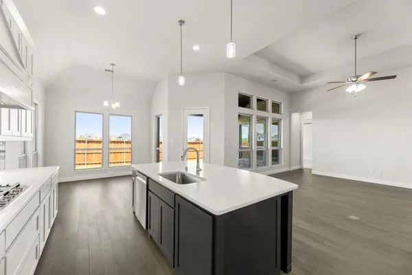 a kitchen with counter top space and wooden floor