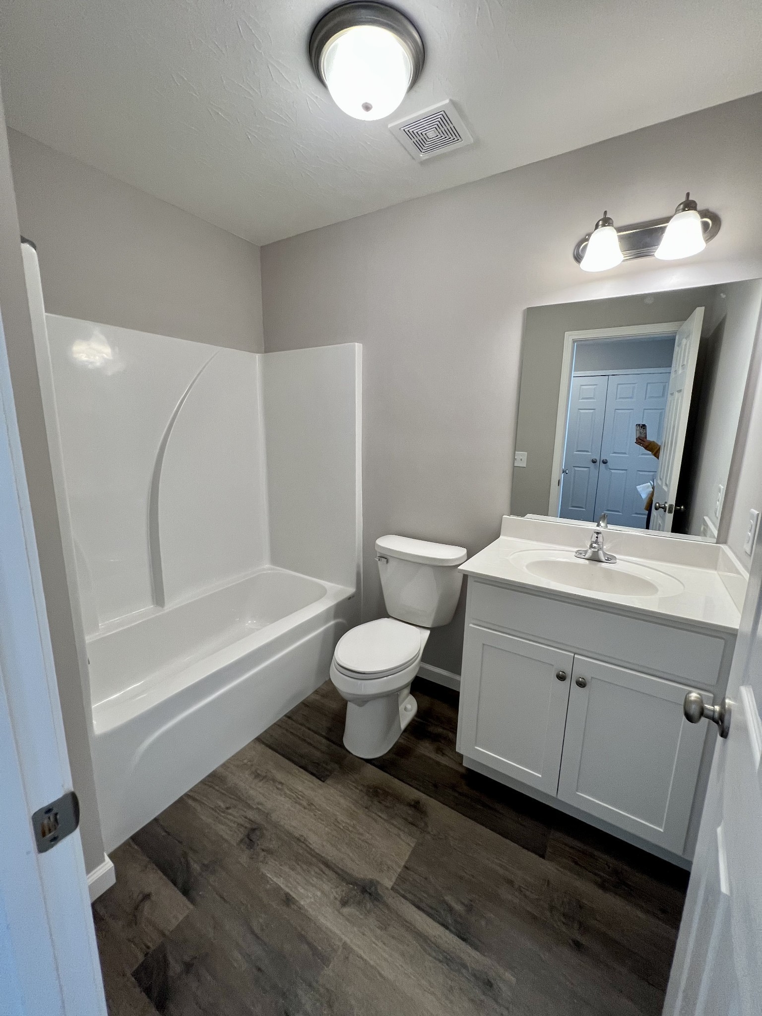 120 Liberty Street Portland, TN 37148 - Photo 11 of 12 a bathroom with a toilet sink a mirror and bathtub