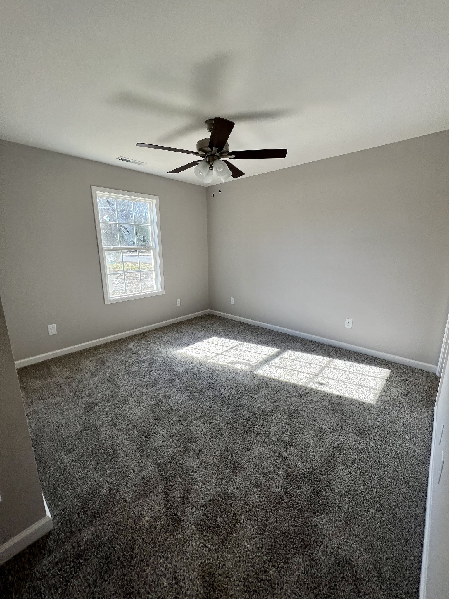 120 Liberty Street Portland, TN 37148 - Photo 8 of 12 an empty room with windows and fan