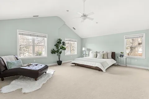 a spacious bedroom with a bed and a large window