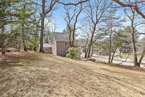 a view of a brick house next to a yard