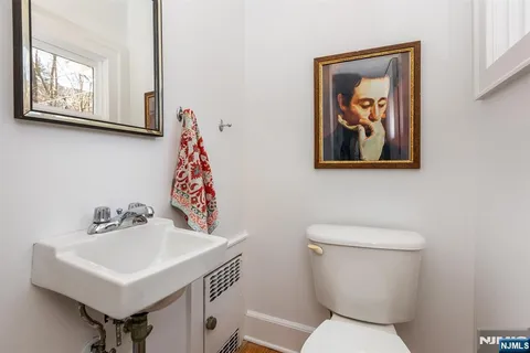 a bathroom with a toilet a sink and a mirror