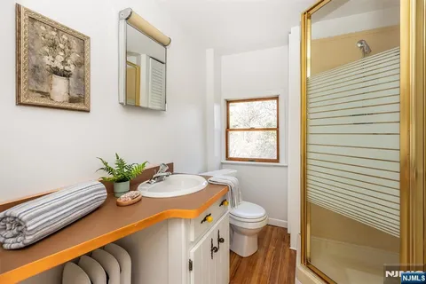 an empty room with a hardwood and windows