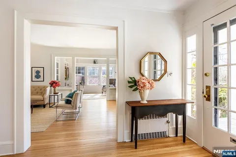 a living room with furniture a window and a dining table
