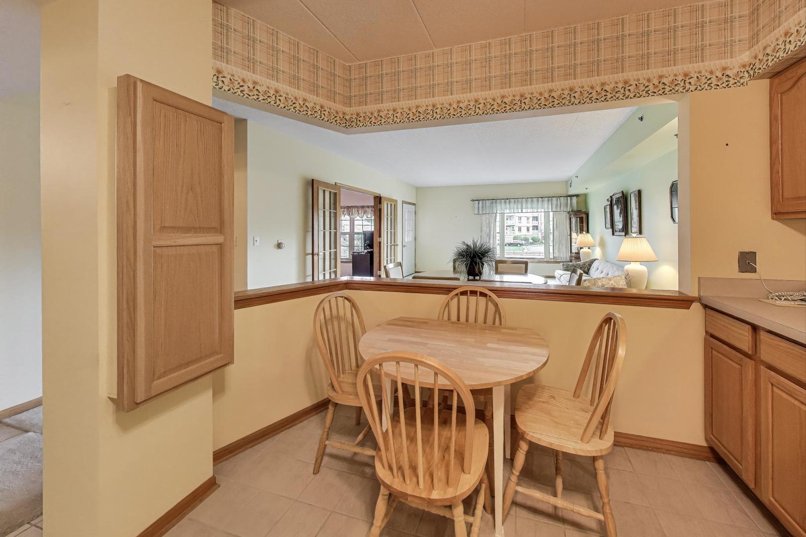 1200 South Prospect Avenue, Unit 108 Elmhurst, IL 60126 - Photo 5 of 19 a dining room with furniture and a window