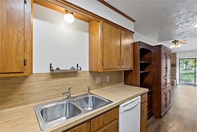 a kitchen with a sink and a refrigerator