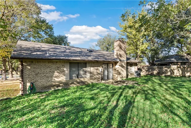 a view of a wooden house with a yard