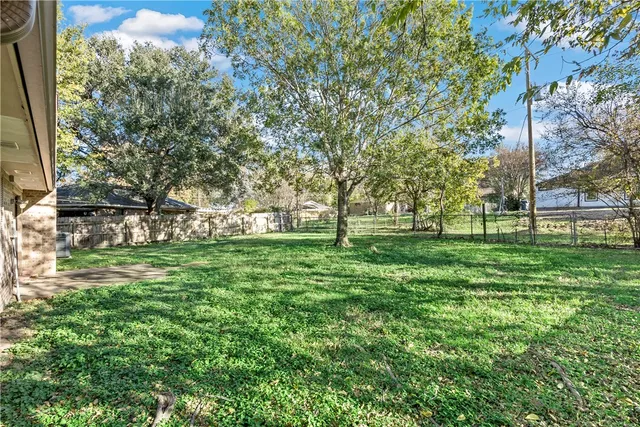 a view of grassy field with benches