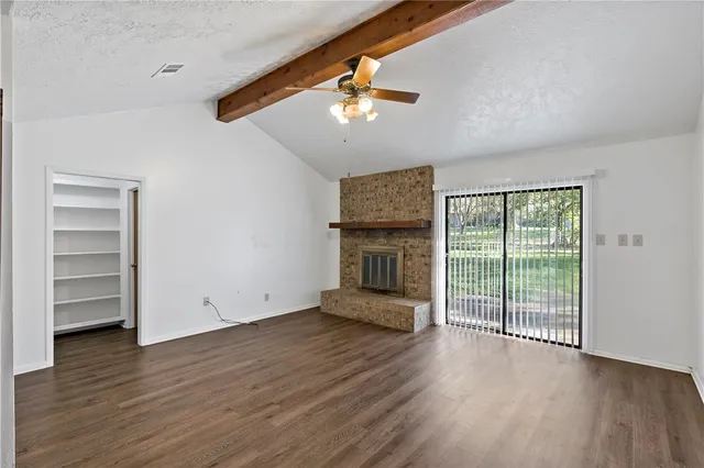 wooden floor in an empty room with a fireplace