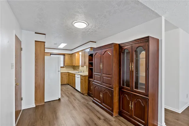 a kitchen with a refrigerator and cabinets