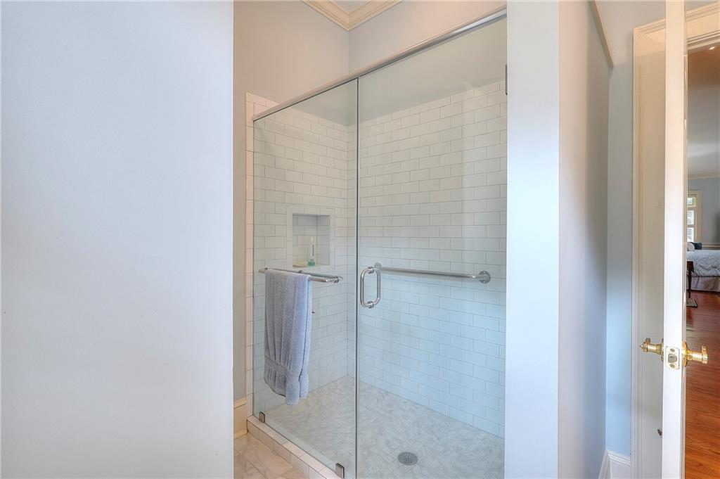 600 River Cove Road Social Circle, GA 30025 - Photo 16 of 45 a bathroom with a glass shower door
