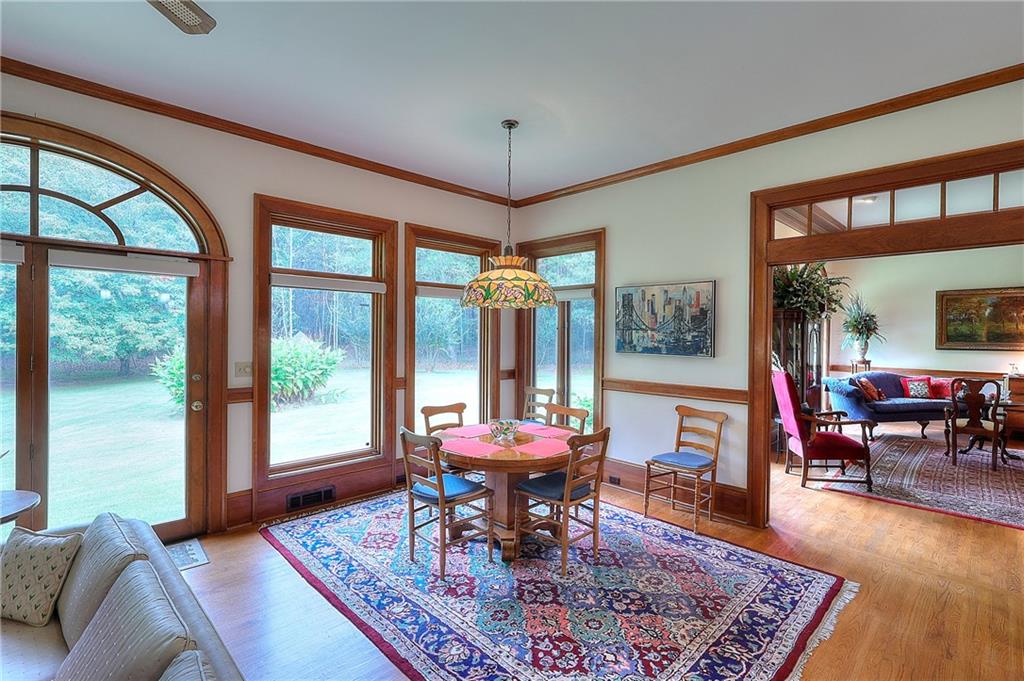 600 River Cove Road Social Circle, GA 30025 - Photo 18 of 45 a living room with furniture a table and large windows