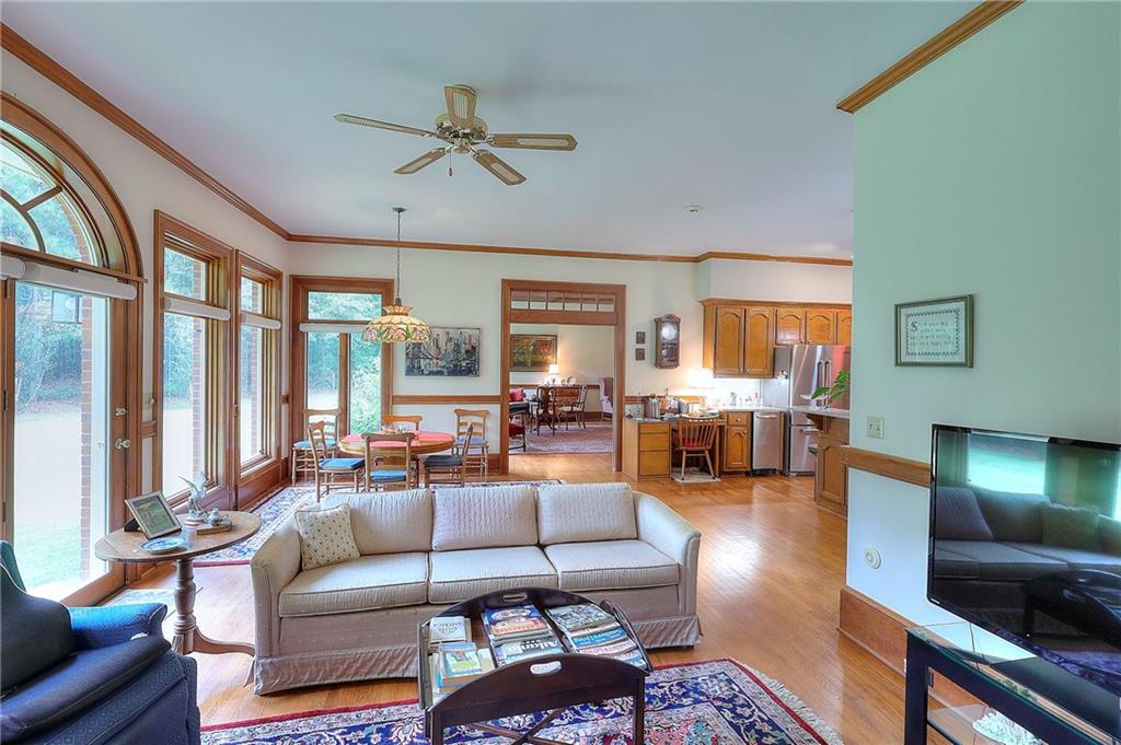 600 River Cove Road Social Circle, GA 30025 - Photo 19 of 45 a living room with furniture and large windows