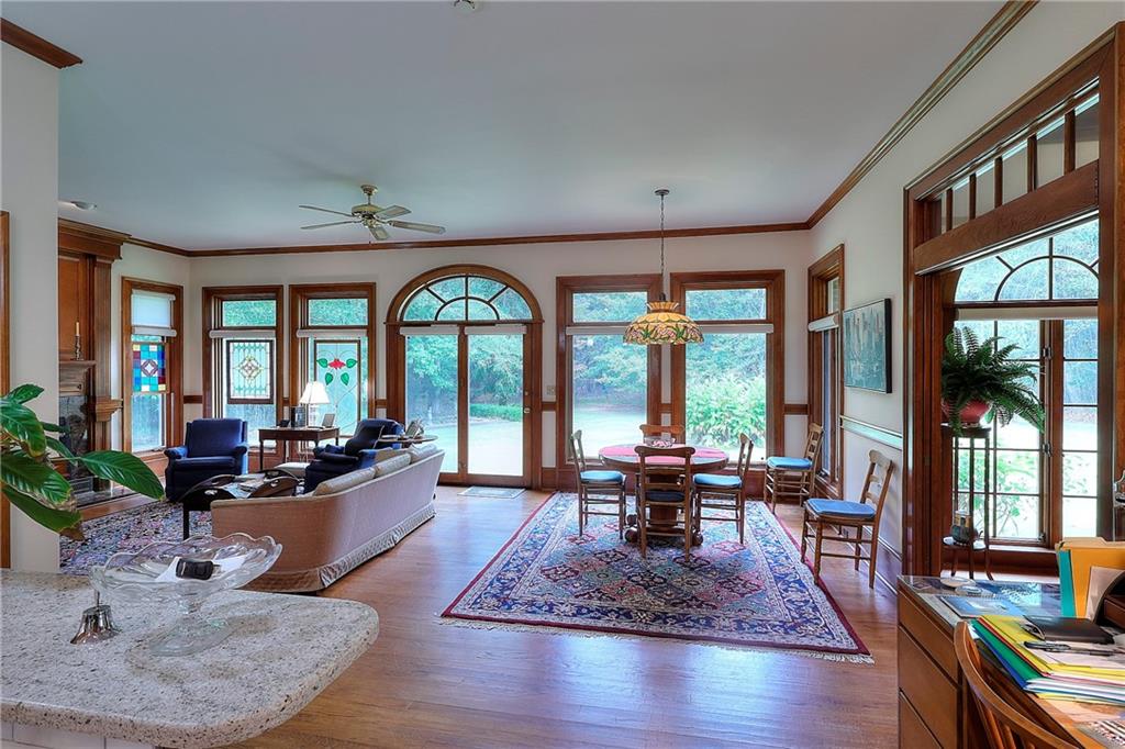 600 River Cove Road Social Circle, GA 30025 - Photo 20 of 45 a living room with furniture large windows and wooden floor