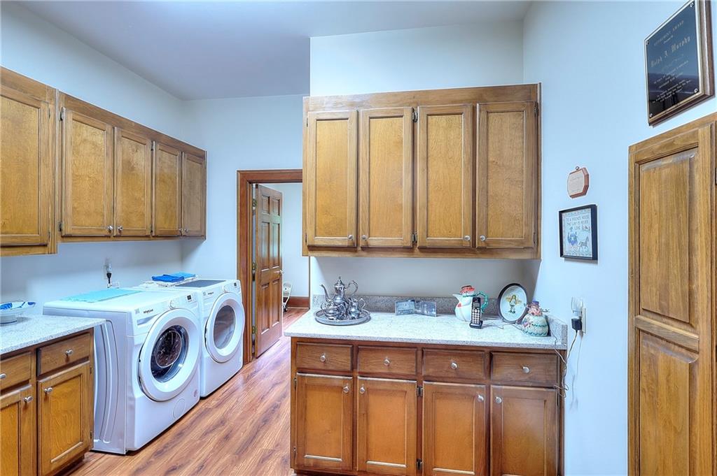 600 River Cove Road Social Circle, GA 30025 - Photo 23 of 45 a utility room with cabinets washer and dryer